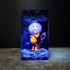 Handcrafted Coraline epoxy resin lamp with yellow raincoat figure, Button Moon, and blue LED lighting on wood base